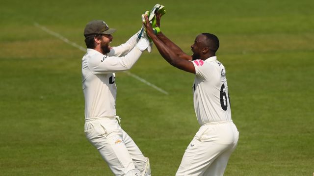 Ben Foakes and Kemar Roach celebrate a wicket