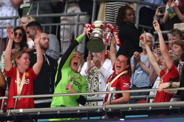 Mary Earps of Manchester United lifts the Adobe Women's FA Cup trophy with teammate Ella Toone after the Adobe Women's FA Cup Final match between Manchester United and Tottenham Hotspur