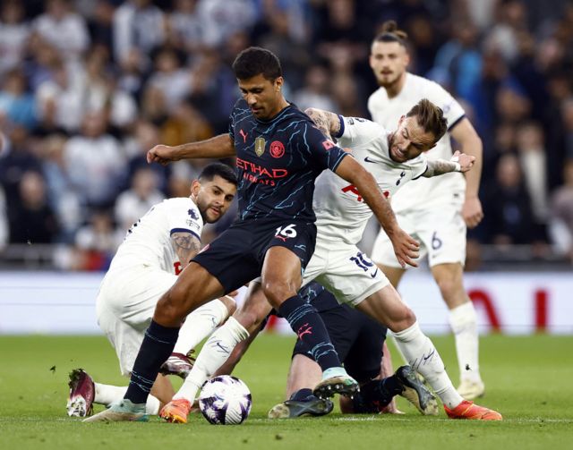 Rodri is challenged by several spurs players