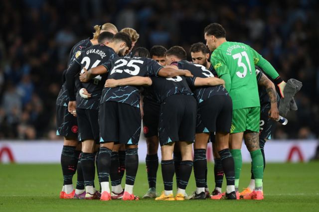 City players huddle on the pitch before the second half