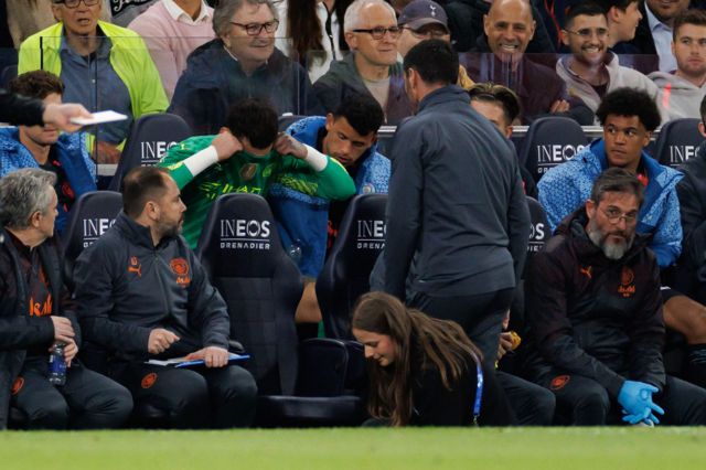 Ederson covers his face with his shirt after being taken off