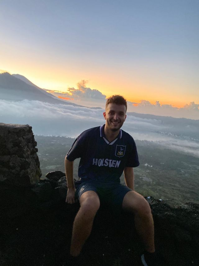 Spurs fan Brandon sits on a viewpoint in his club shirt