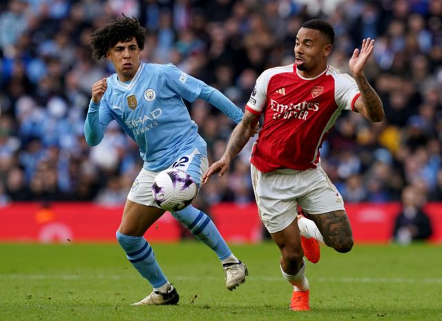 Manchester City's Rico Lewis and Arsenal's Gabriel Jesus chase the ball