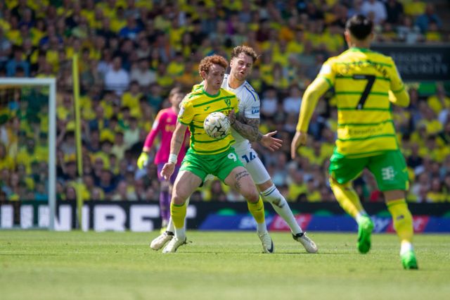 Josh Sargent of Norwich City is being pressured by Joe Rodon of Leeds United during the Championship play-off semi-final first leg