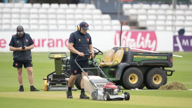 Groundsman mows the lawn at Essex