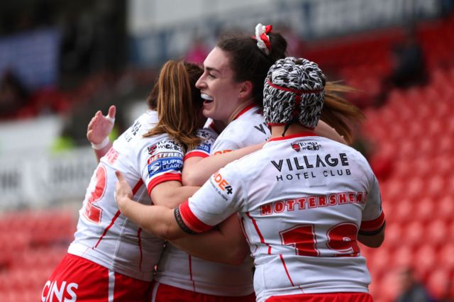 Leah Burke celebrates scoring a try for St Helens