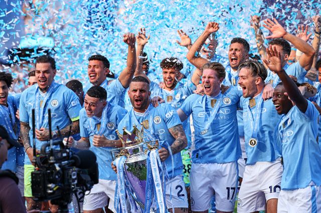 Kyle Walker of Manchester City lifts the Premier league trophy