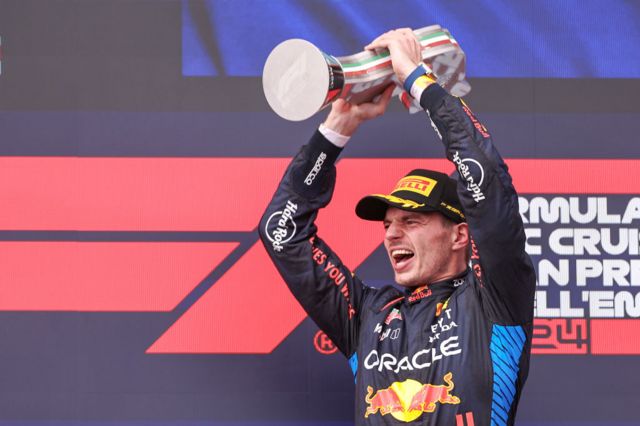 Max Verstappen holds up the winner's trophy at Imola
