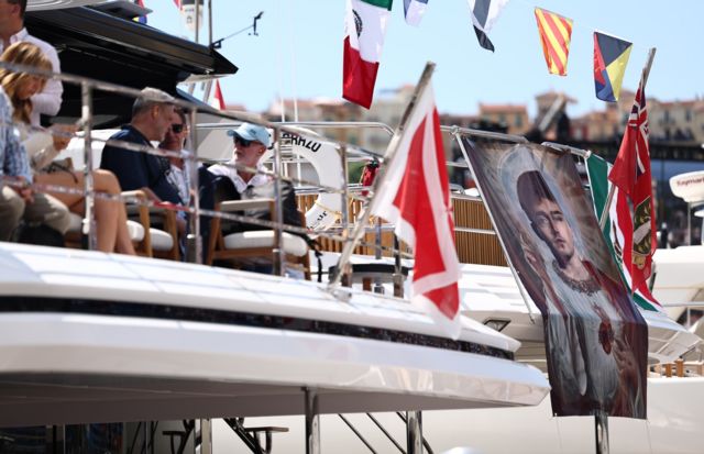 A banner of Charles Leclerc hangs over a boat in Monaco