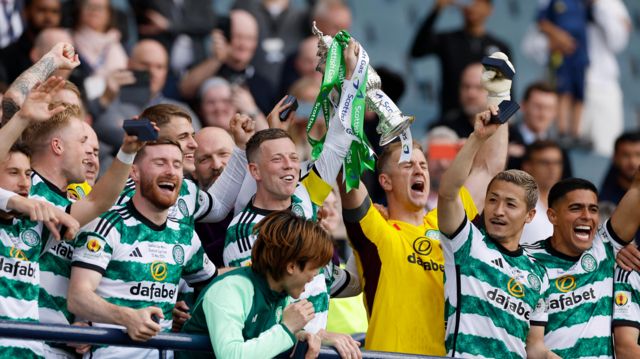 Callum McGregor and teammates lift the Scottish Cup