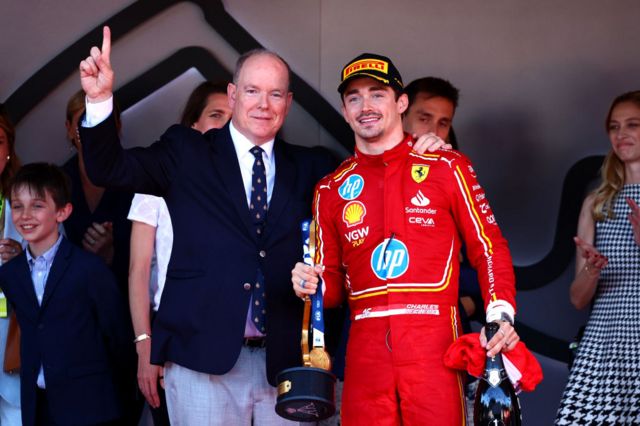 Prince Albert of Monaco poses with Charles Leclerc on the podium