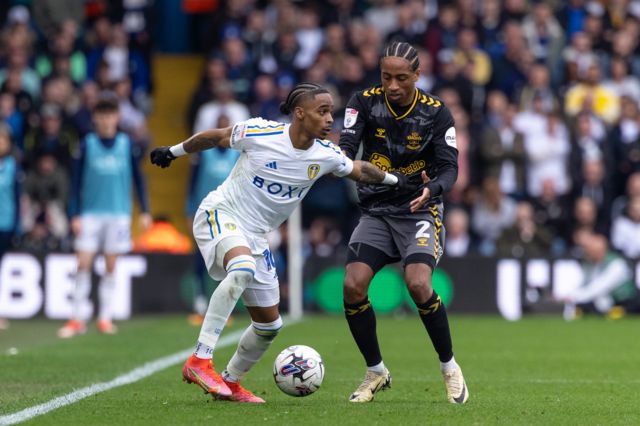 Crysencio Summerville of Leeds United is battling with Kyle Walker-Peters of Southampton