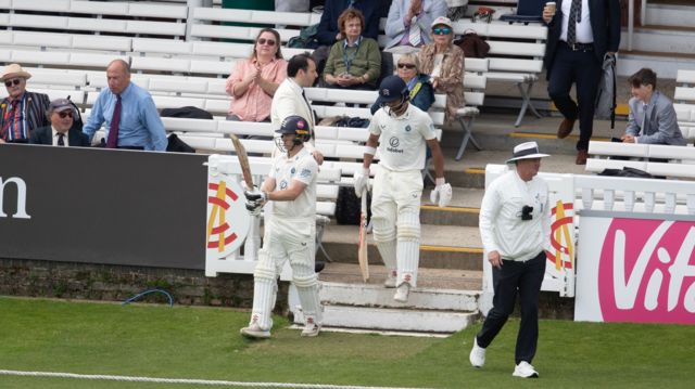 Jack Davies and Nathan Fernandes come out to bat at start of play