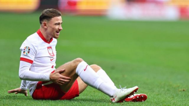Poland's Matty Cash reacts after picking up an injury during the Euro 2024 play-offs