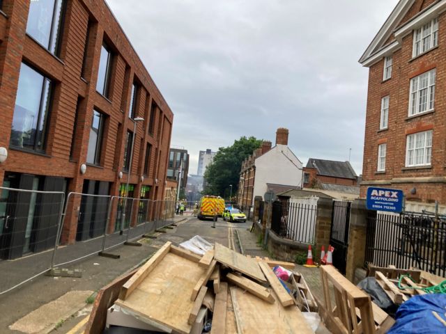 The cordon in place in the background, with a pile of waste in the foreground