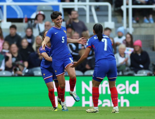 France's Elisa De Almeida celebrates scoring their first goal with Sakina Karchaoui
