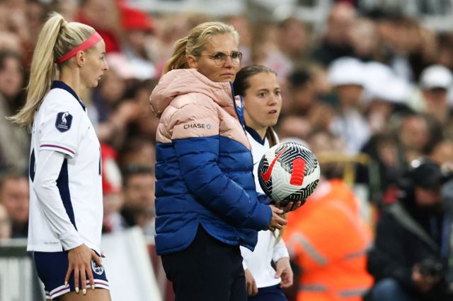 Fran Kirby and Chloe Kelly prepare to come on for England