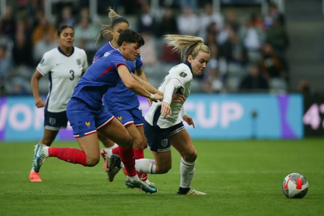 France's Elisa De Almeida (left) and England's Lauren Hemp battle for the ball during the UEFA Women's Euro 2025 qualifying League A, Group A3 match at St. James' Park, Newcastle upon Tyn