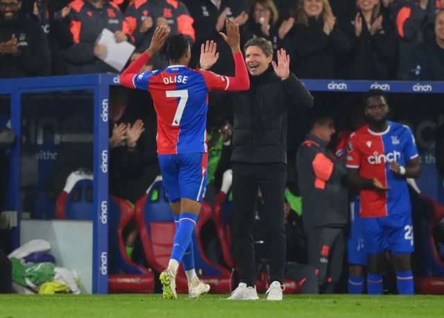 Oliver Glasner and Michael Olise high five after Crystal Palace's victorty over Manchester United