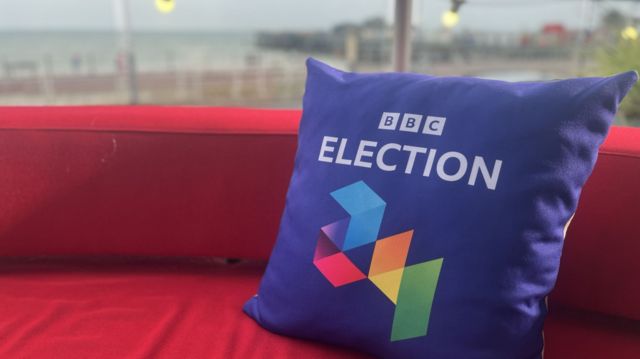 A BBC election pillow in front of Hastings Pier