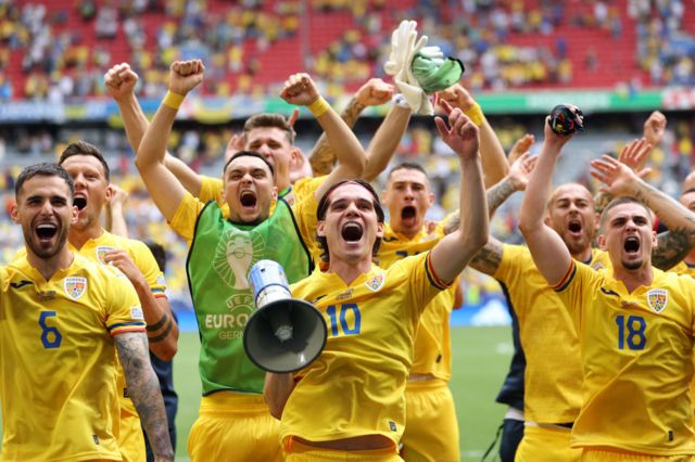 Romania players celebrate victory