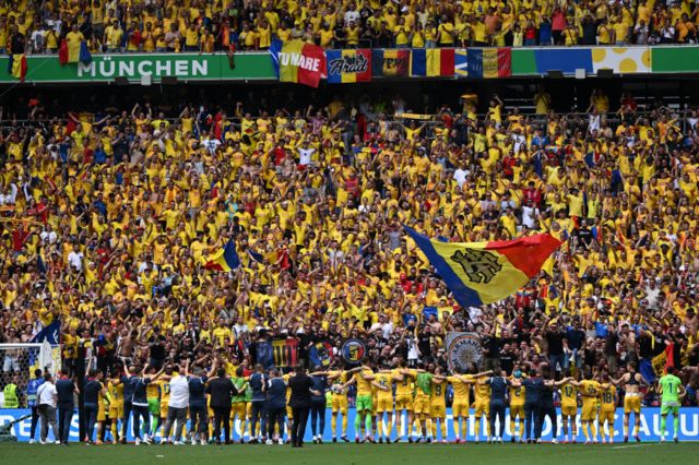 Romania fans and players celebrate