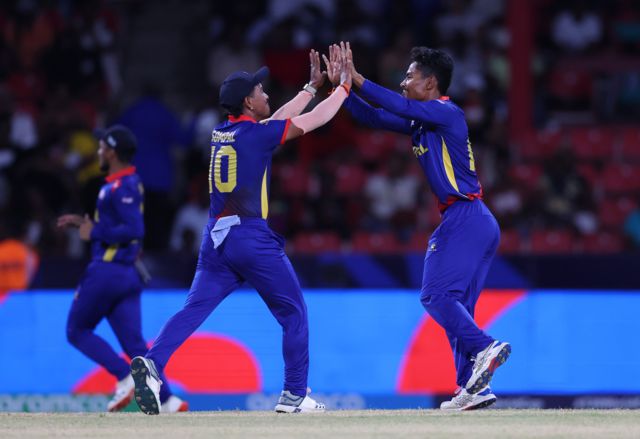 Rohit Paudel of Nepal celebrates with teammate Sompal Kami after dismissing Tawhid Hridoy of Bangladesh (not pictured) during the ICC Men's T20 Cricket World Cup West Indies & USA 2024 match