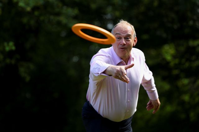 British leader of the Liberal Democrats party Ed Davey plays a lawn game as he attends a Liberal Democrats general election campaign event in Hampshire