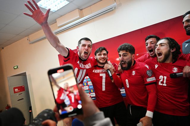 Giorgi Chakvetadze, Khvicha Kvaratskhelia, Zuriko Davitashvili and Giorgi Tsitaishvili of Georgia celebrate in the dressing room after the team's victory in the UEFA EURO 2024 Play-Offs final match