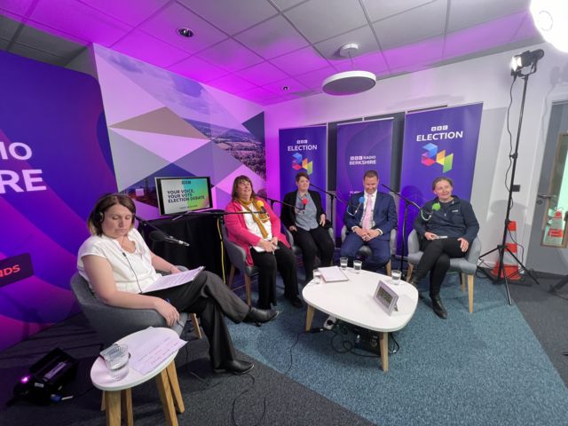 Host Sarah Walker and four candidates sat around a coffee table in a purple room