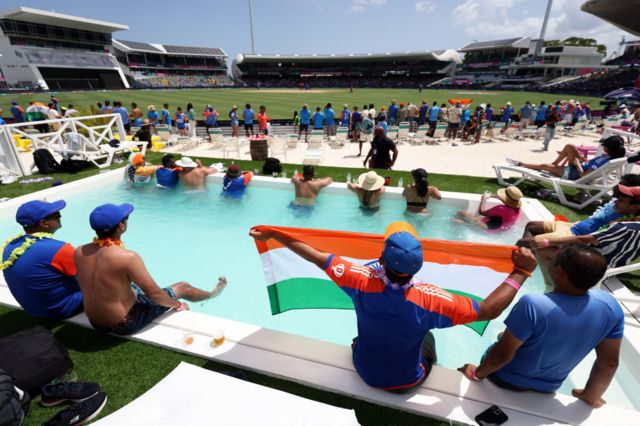 Fans watch India v Afghanistan from a pool