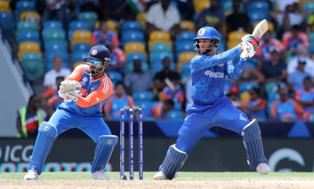 Azmutullah Omarzai of Afghanistan plays a shot as Rishabh Pant of India keeps during the ICC Men's T20 Cricket World Cup West Indies & USA 2024 Super Eight match between Afghanistan and India