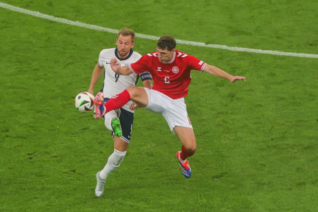 Harry Kane challenges for the ball