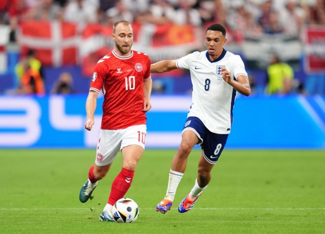 Denmark's Christian Eriksen runs with the ball while being pursued by England's Trent Alexander-Arnold during their group game at Euro 2024