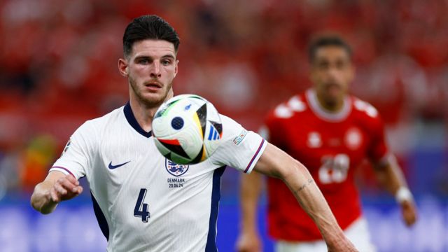 Declan Rice watches the ball while playing for England against Denmark at Euro 2024