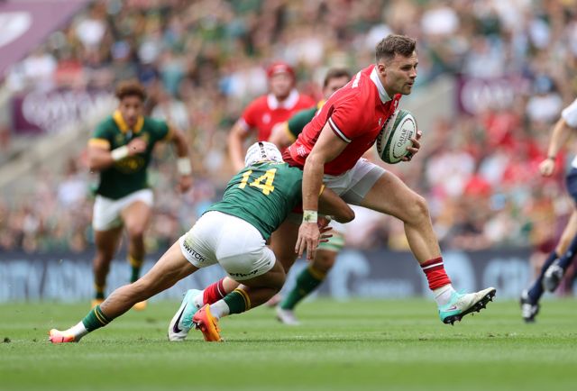 Mason Grady of Wales is tackled by Edwill van der Merwe