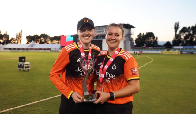 Sarah Bryce and Kathryn Bryce hold the Charlotte Edwards Cup trophy