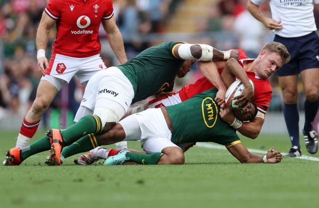 Grant Williams of South Africa is tackled by Taine Plumtree