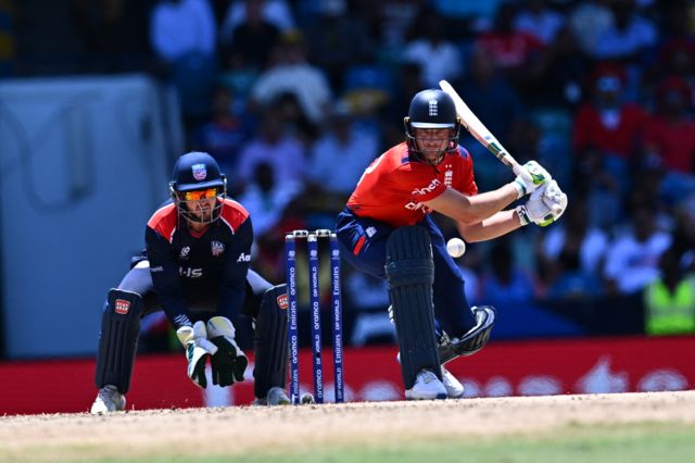 Jos Buttler sweeps for four