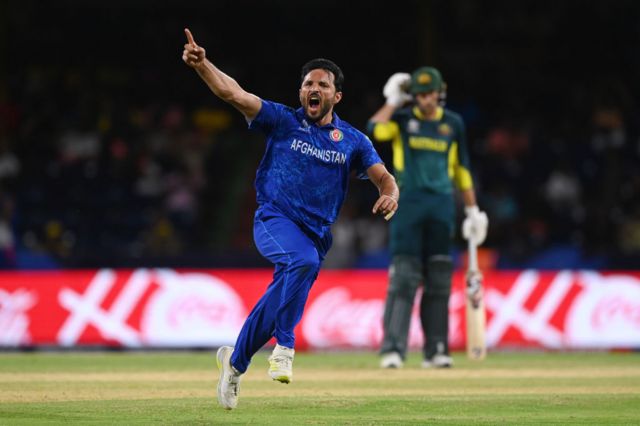 Gulbadin Naib celebrates taking a wicket