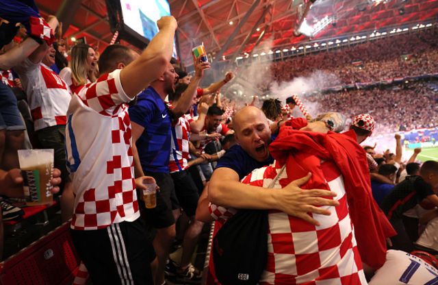 : Fans of Croatia celebrate after Luka Modric of Croatia (not pictured) scores his team's first goal