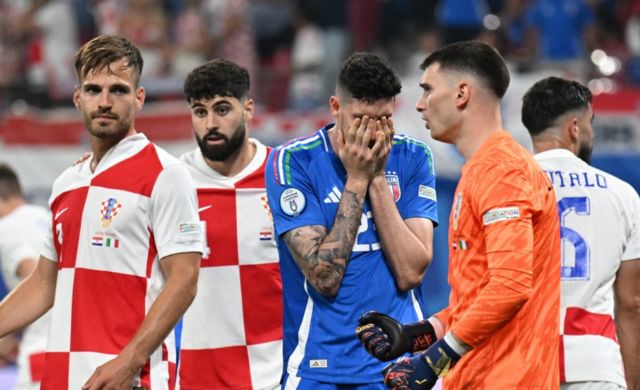 Italy's Alessandro Bastoni and Croatia's Dominik Livakovic reacts