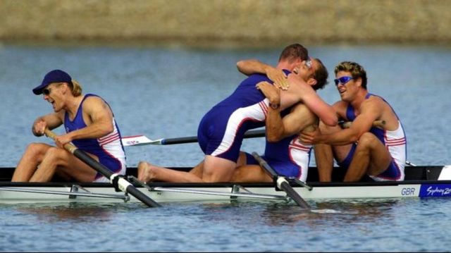 Great Britain rowers Matthew Pinsent and James Cracknell congratulate Steve Redgrave after Team GB won the Gold Medal in the Mens Coxless Four Final at the Olympic Games in Sydney