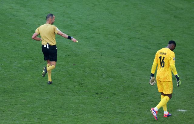 Referee Marco Guida (L) awards Poland a penalty during the UEFA EURO 2024 group D soccer match between France and Poland