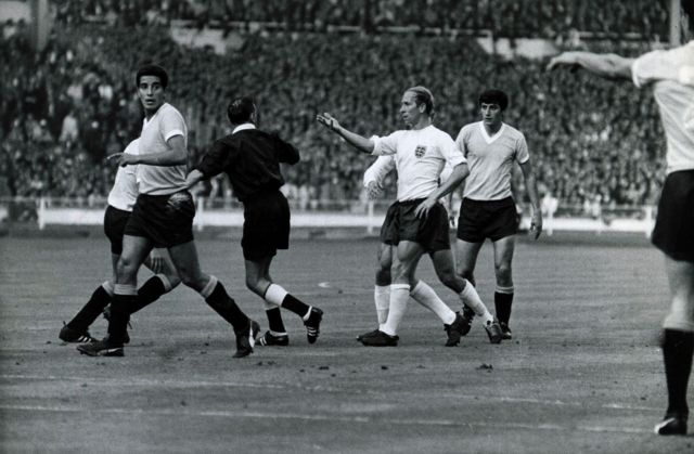 Bobby Charlton appeals to referee Istvan Zsolt after being fouled by Uruguay during England's 1966 World Cup opener