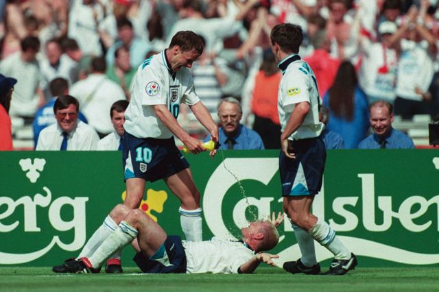 Teddy Sheringham of England squirts water at Paul Gascoigne in celebration against Scotland at Euro 96