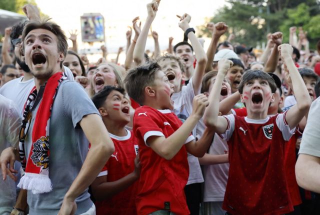 Austria fans celebrate after Austria's Marcel Sabitzer scores their third goal, at the City Hall square in Vienna