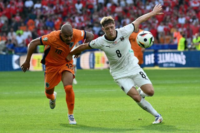 Netherlands' forward Donyell Malen fights for the ball with Austria's midfielder Alexander Prass