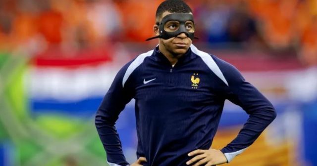 Kylian Mbappe wears a protective mask