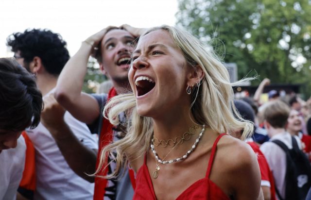 Austria fans celebrate after Austria's Marcel Sabitzer scores their third goal, at the City Hall square in Vienna